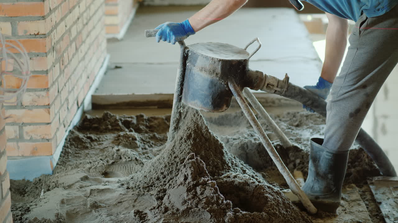 건축업자는 바닥 마감을 위해 반건조 박격포를 놓는다