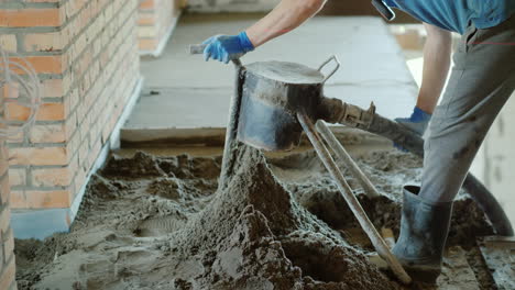 The-Builder-Puts-A-Semi-Dry-Mortar-For-Finishing-The-Floor