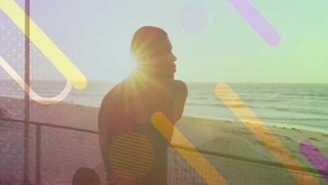 Animation-of-moving-shapes-over-african-american-man-stretching-at-beach