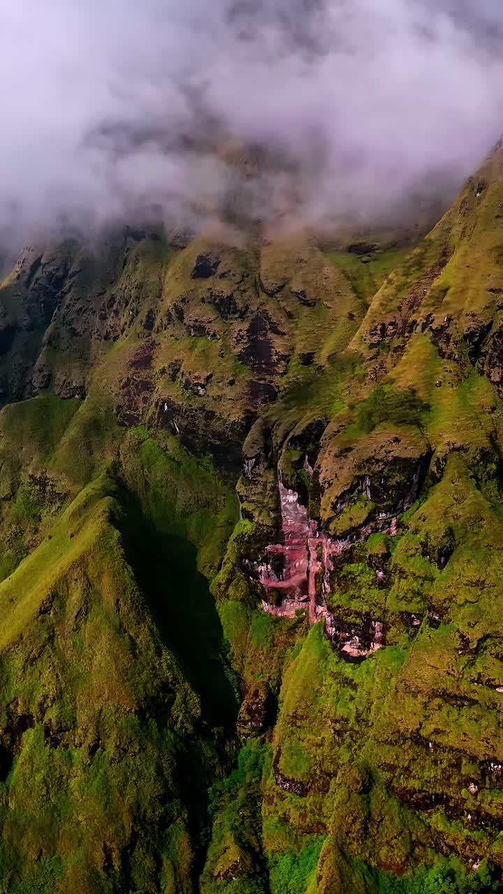 Aerial Bukit Selong farmland patterns surrounded by mountains and morning mist valley