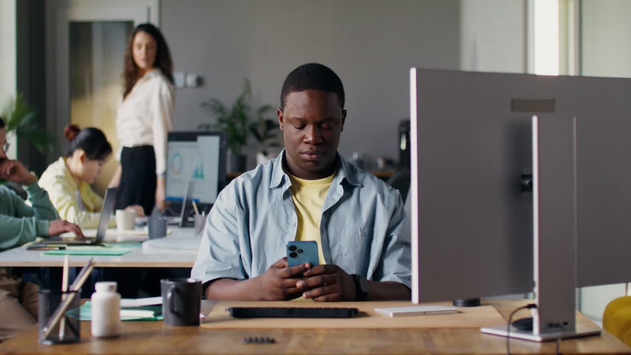 Man using smartphone in an office setting