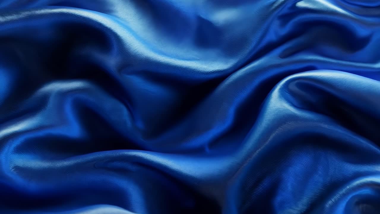 A blue fabric with a wave pattern. The wave pattern is very prominent and the fabric is very smooth