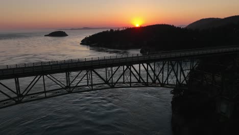 aerial shot of an empty deception pass bridge during a warm summer sunset