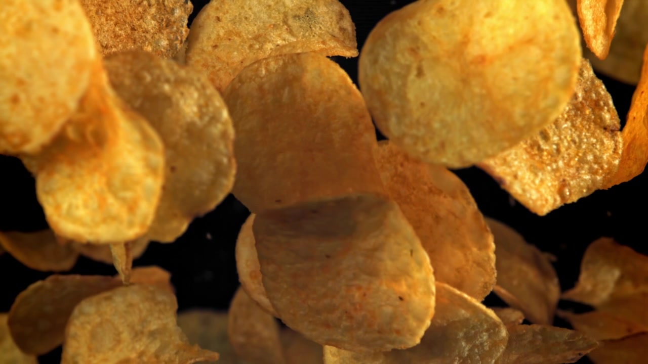 Delicious Golden Potato Chips Falling in Super Slow Motion