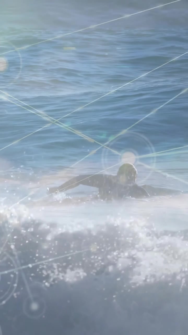 Vertical video: After swells surfer paddling out on board, tech HUD nodes tracking motion