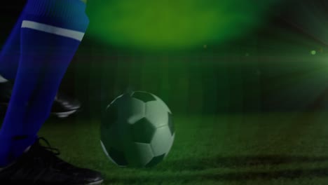 Animation-of-green-spot-of-light-against-mid-section-of-male-soccer-player-practicing-soccer