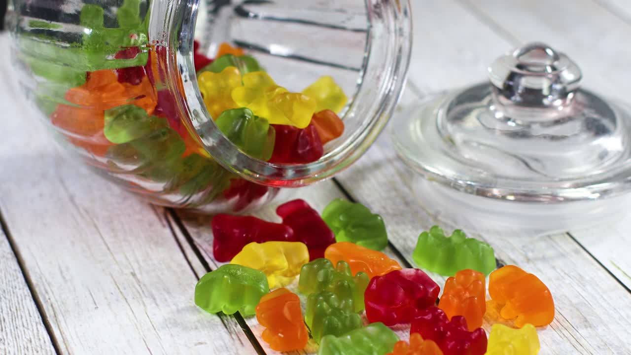 Gummy bears in glass jar on wooden theme