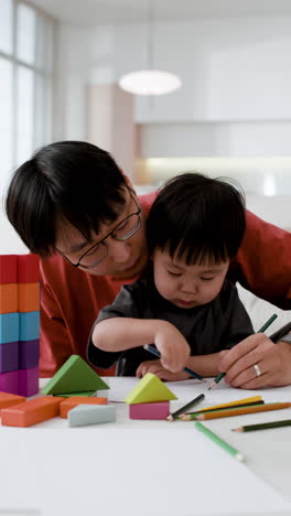 father and child drawing together