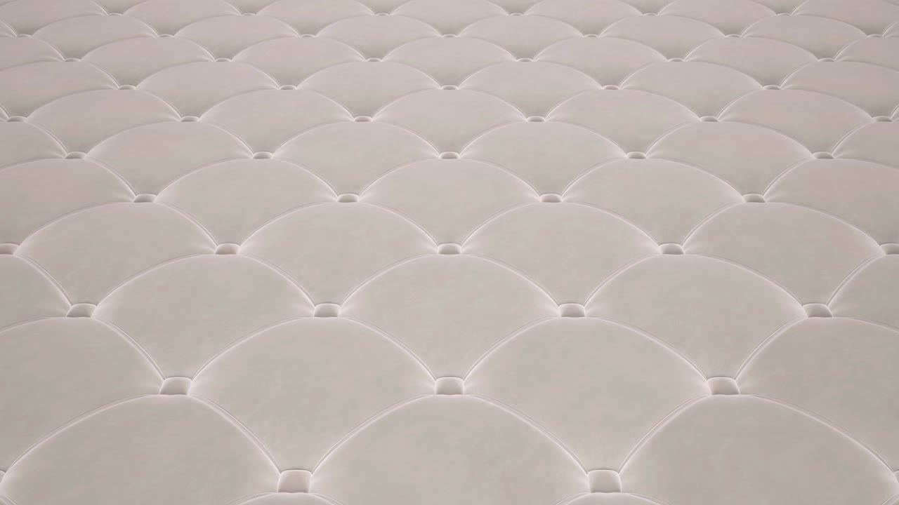 animación 3d del vuelo sobre una superficie de terciopelo acolchado blanco. video en bucle.