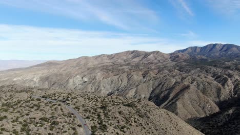 Car-driving-on-scenic-highways-of-Cahuilla-Mountains,-Scenic-road-through-vast-desert-landscape,-California,-USA