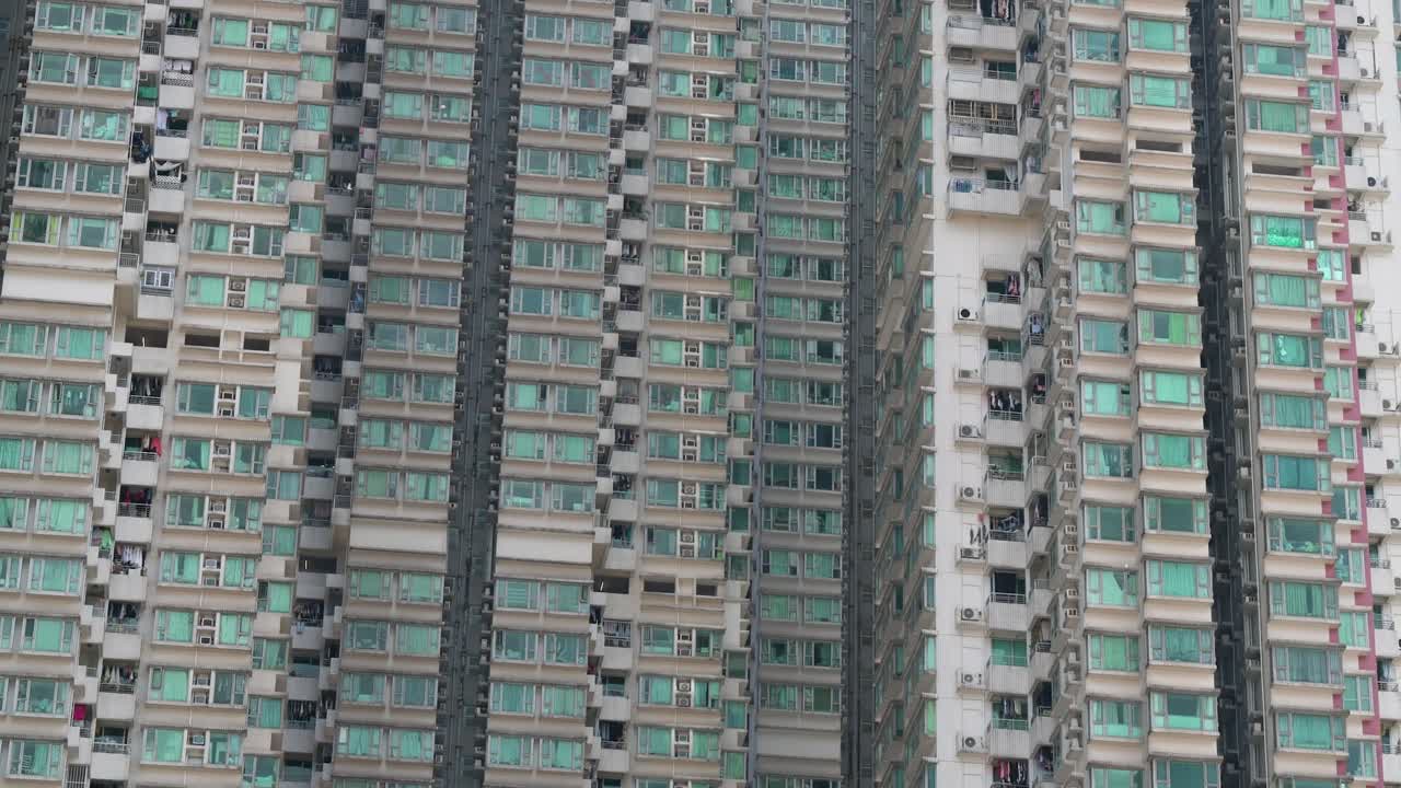 View of dense residential high-rises in Kowloon, Hong Kong, emphasizing urban density and compact living spaces.