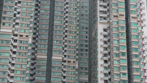 view of dense residential high-rises in kowloon, hong kong, emphasizing urban density and compact living spaces.