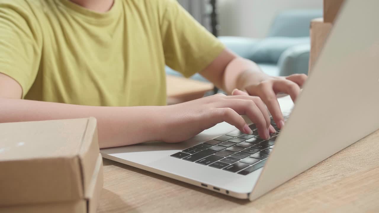Child working on a laptop with boxes