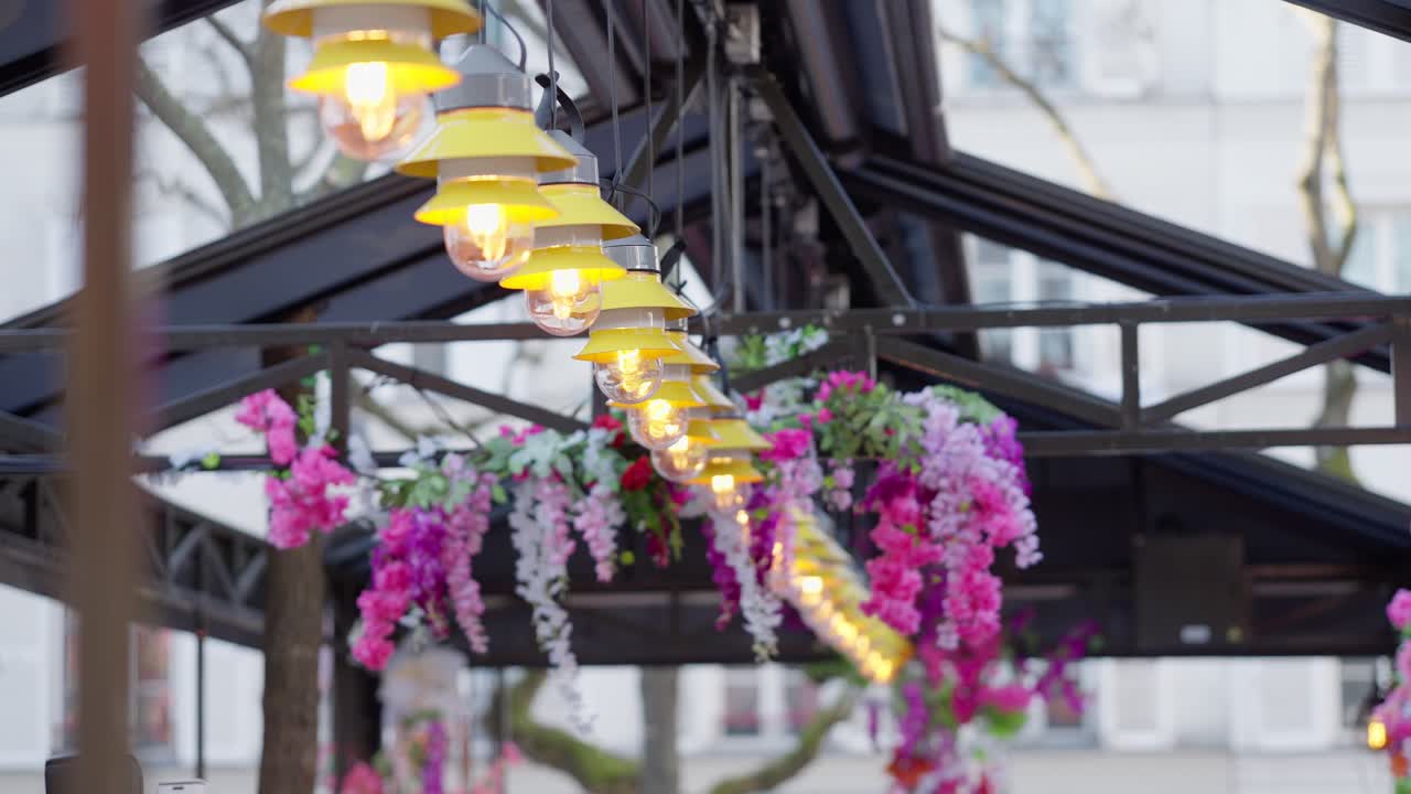 Long shot view of Light bulbs flickering in a coffee shop in Montmartre Paris