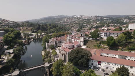 Establishing-shot-featuring-Sao-Goncalo-monastery,-tamega-river-and-mountainous-landscape