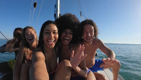 happy multiracial friends streaming live video while doing sea tour with sailing boat