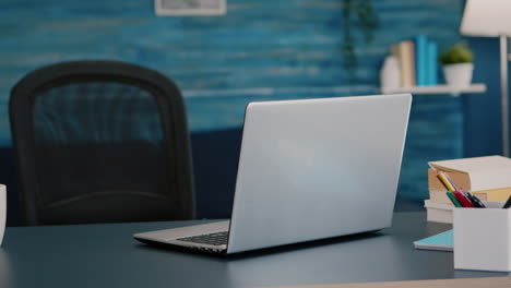 close up of laptop computer placed on modern working desk in empty home