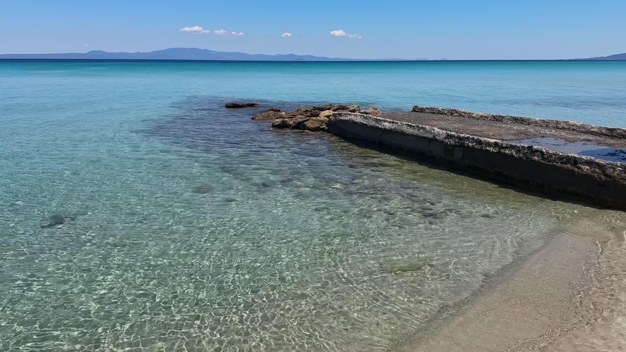 Stunning beach scene in Halkidiki, Greece, with elegant sunbeds facing the crystal-clear turquoise sea. A perfect summer escape in the heart of the Aegean.