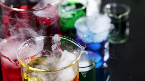 beakers with dry ice create colorful smoke