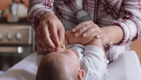 mother giving baby teething ring toddler with loving mom caring for newborn at home enjoying motherhood