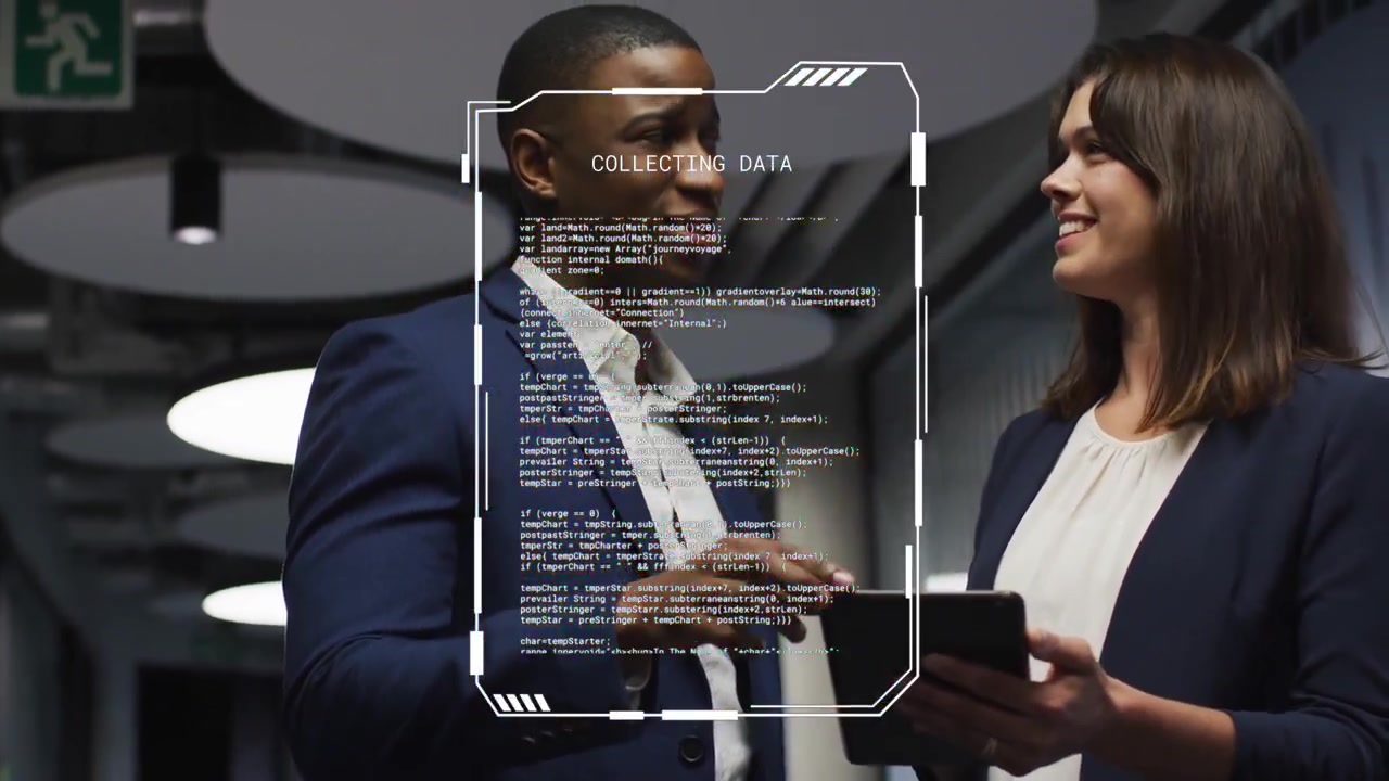 Man pointing and woman holding tablet, reviewing code in office corridor, causing AR UI flickering