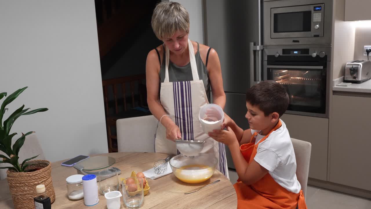 Mother and son baking together in the kitchen