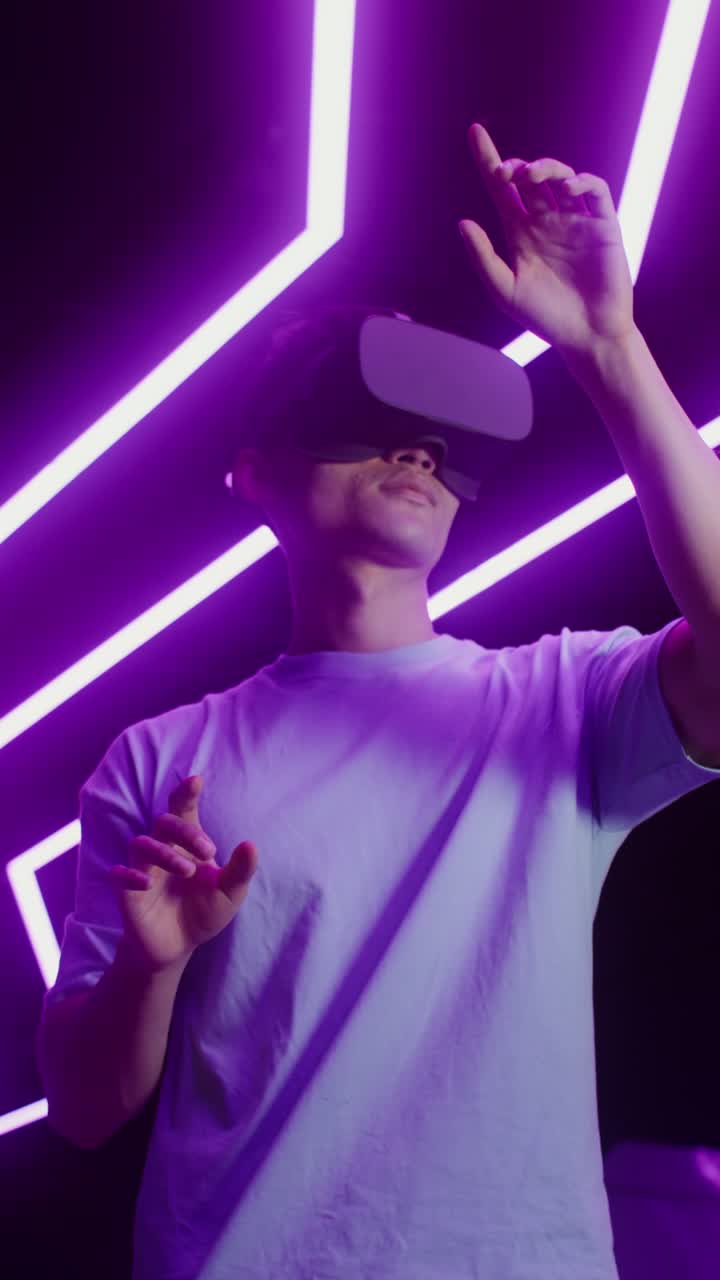 Man using a virtual reality headset with purple lighting