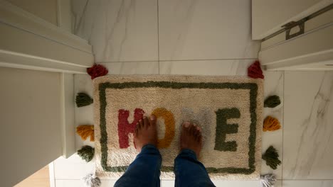 barefoot on a colorful home doormat