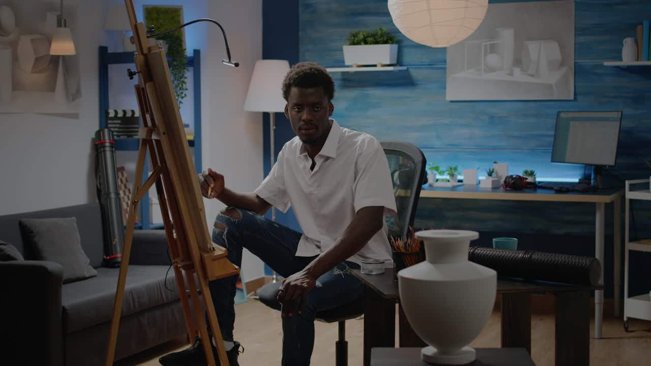 Young black artist drawing and getting inspiration