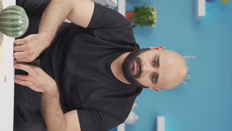 vertical video of unhappy man living poor.