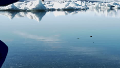 Young-Male-Traveler-skipping-stones-in-Iceland