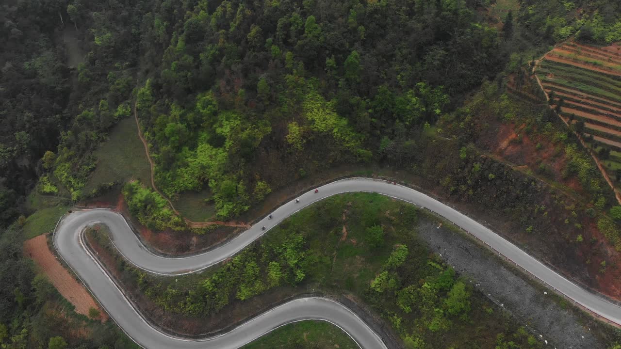 Motorbikes driving on Ch&iacute;n Khoanh ramp at Ha giang Vietnam, aerial