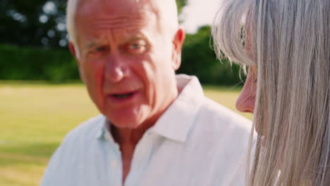 Retired-Couple-Enjoying-Afternoon-Tea-In-Garden-At-Home