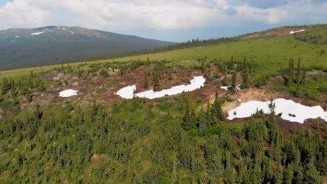 4k drone video of snow patches on wickersham dome in the white mountains of alaska on sunny summer day