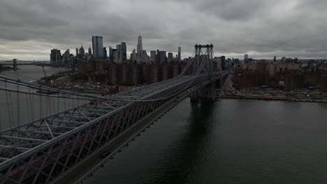 A-high-angle-aerial-view-of-Lower-Manhattan-from-over-the-Williamsburg-Bridge-in-NY-on-a-cloudy-day