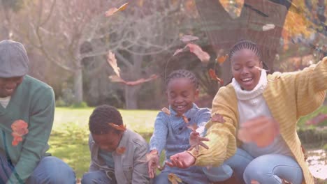 Animation-of-african-american-family-playing-in-park-over-leaves