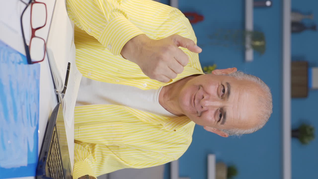 Vertical video of Home office worker old man says come to camera, calling you.
