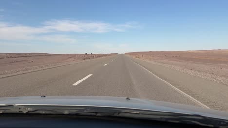 Iceland-roadtrip-in-summer-season-driving-pov-blue-sky-white-clouds-desert-landscape-wide-view-background-sunset-time-in-a-hazy-day-in-Texas-asphalt-empty-pathway-lonely-journey-panorama-scenic-shot