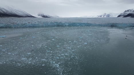 ice floating on water in front of a glacier in the arctic sea north of svalbard