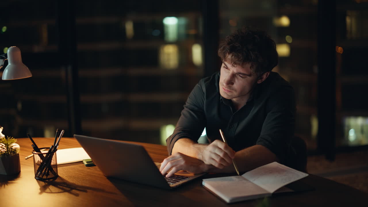 Overworked manager planning budget looking laptop at night workplace closeup