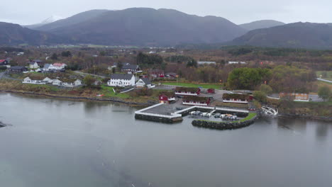 small jetty at the coast of norwegian sea with the atlantic road cabins in averoy, norway