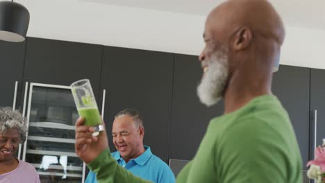 Gente-Feliz-Y-Diversa-Bebiendo-Bebidas-Saludables-En-La-Cocina-De-La-Casa-De-Retiro