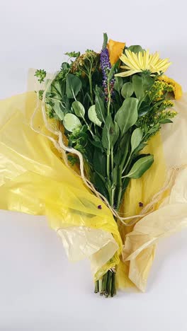 yellow wrapped mixed flower bouquet