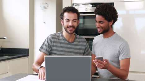 Happy-homosexual-couple-using-computer