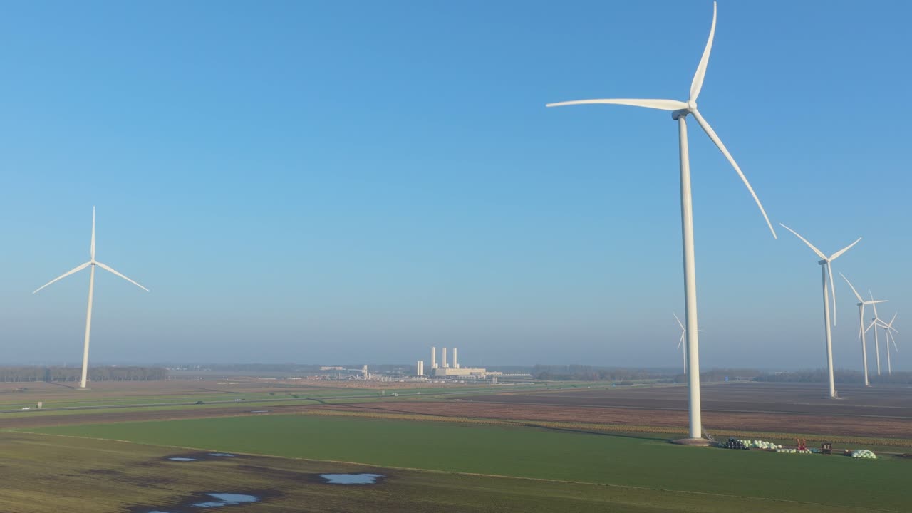 Wind turbines generating renewable energy with nitrogen plant in background