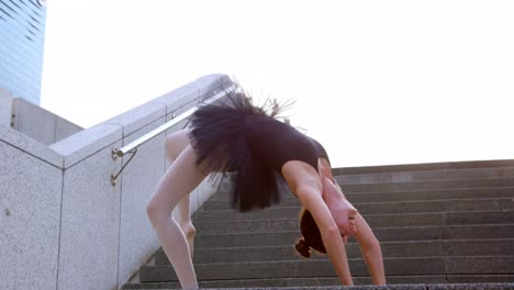 female ballet dancer stretching on the stair 4k