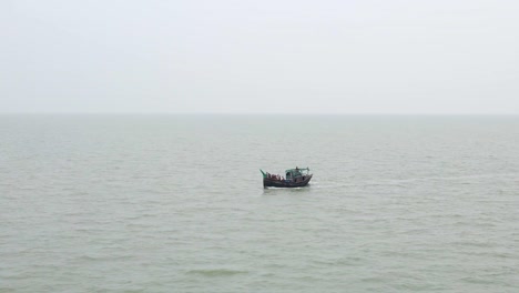 fishing trawler ventured into the deep indian ocean, despite the monsoon's gloomy weather - drone flying forward