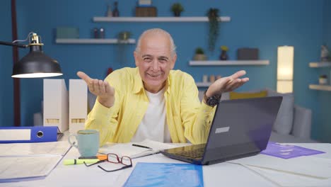 home office worker old man making cute gesture at camera.