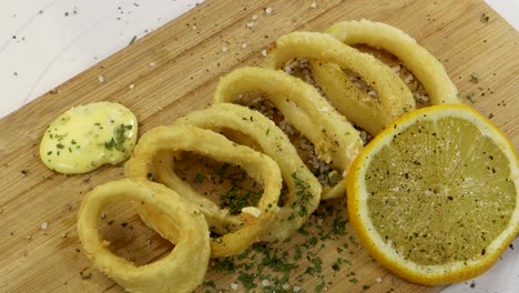 adding salt to fried squid rings