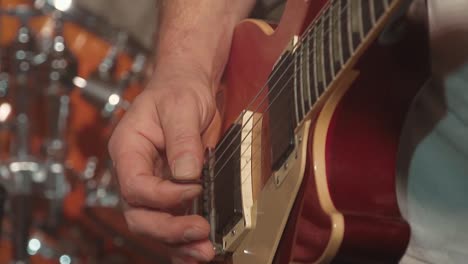 guitarist plays the guitar as part of a band at a concert